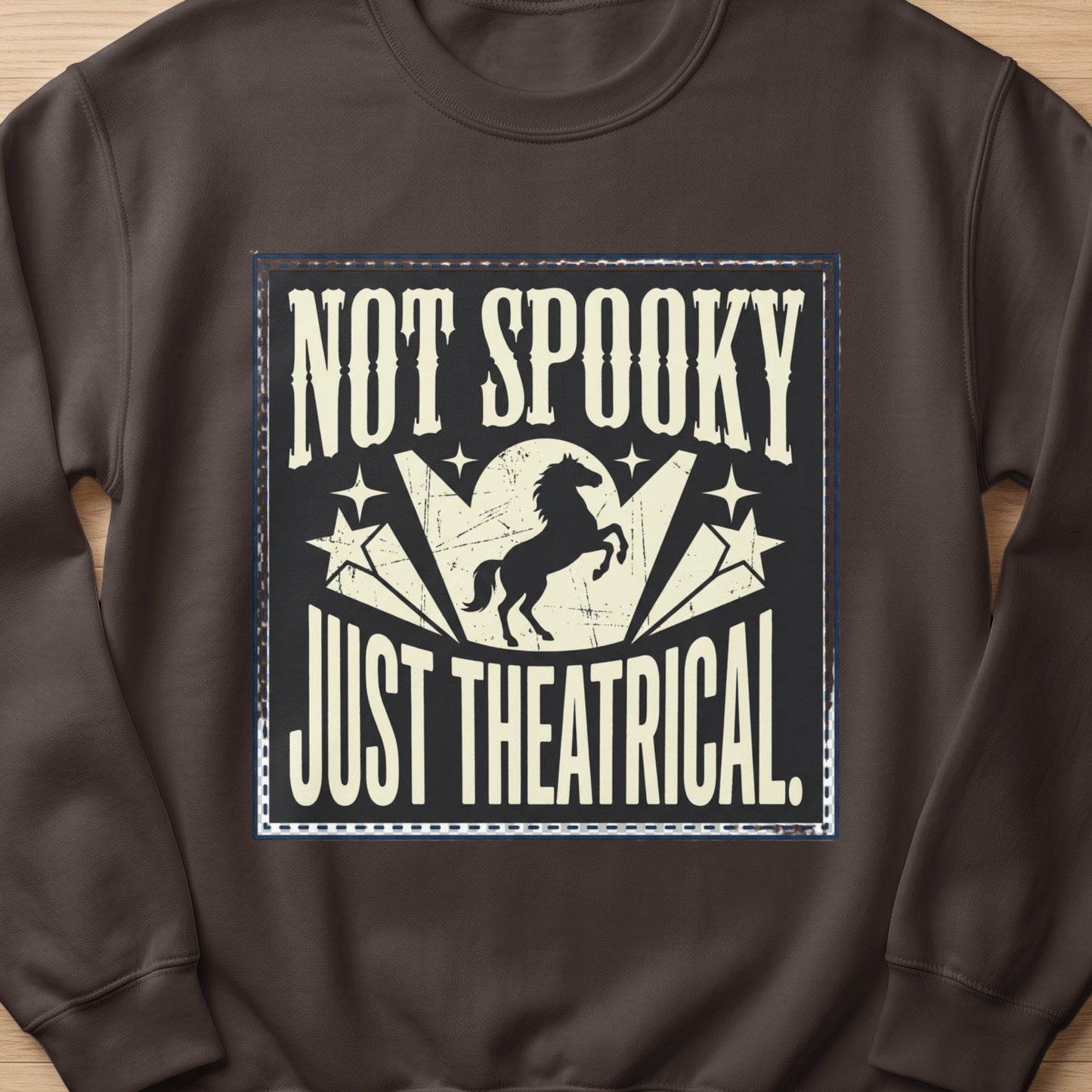 Dark brown sweatshirt with "NOT SPOOKY JUST THEATRICAL" text and a silhouette of a horse.