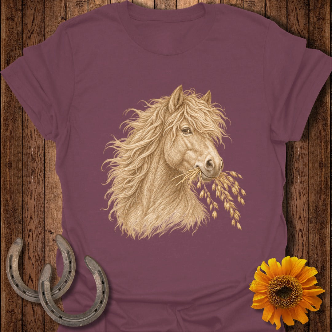 Illustration of a blonde horse with flowing mane eating oats on a maroon shirt.