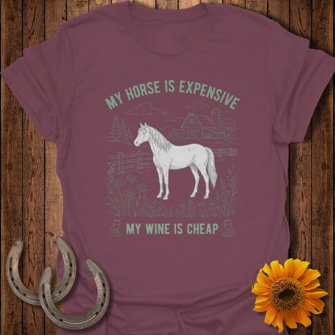 Maroon t-shirt with white line drawing of a horse and barn, text reads "MY HORSE IS EXPENSIVE MY WINE IS CHEAP."