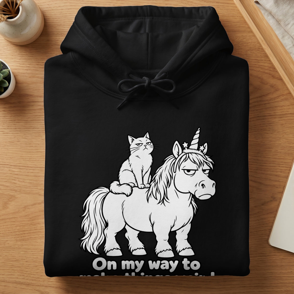 Black hoodie with a graphic of a grumpy cat riding a grumpy unicorn.