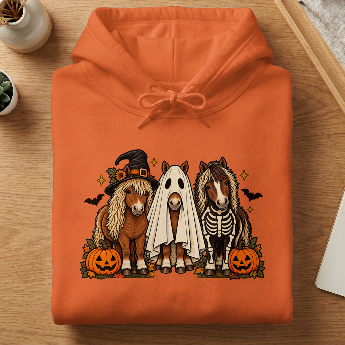 Three horses in Halloween costumes: witch hat, ghost, and skeleton, with pumpkins and bats.