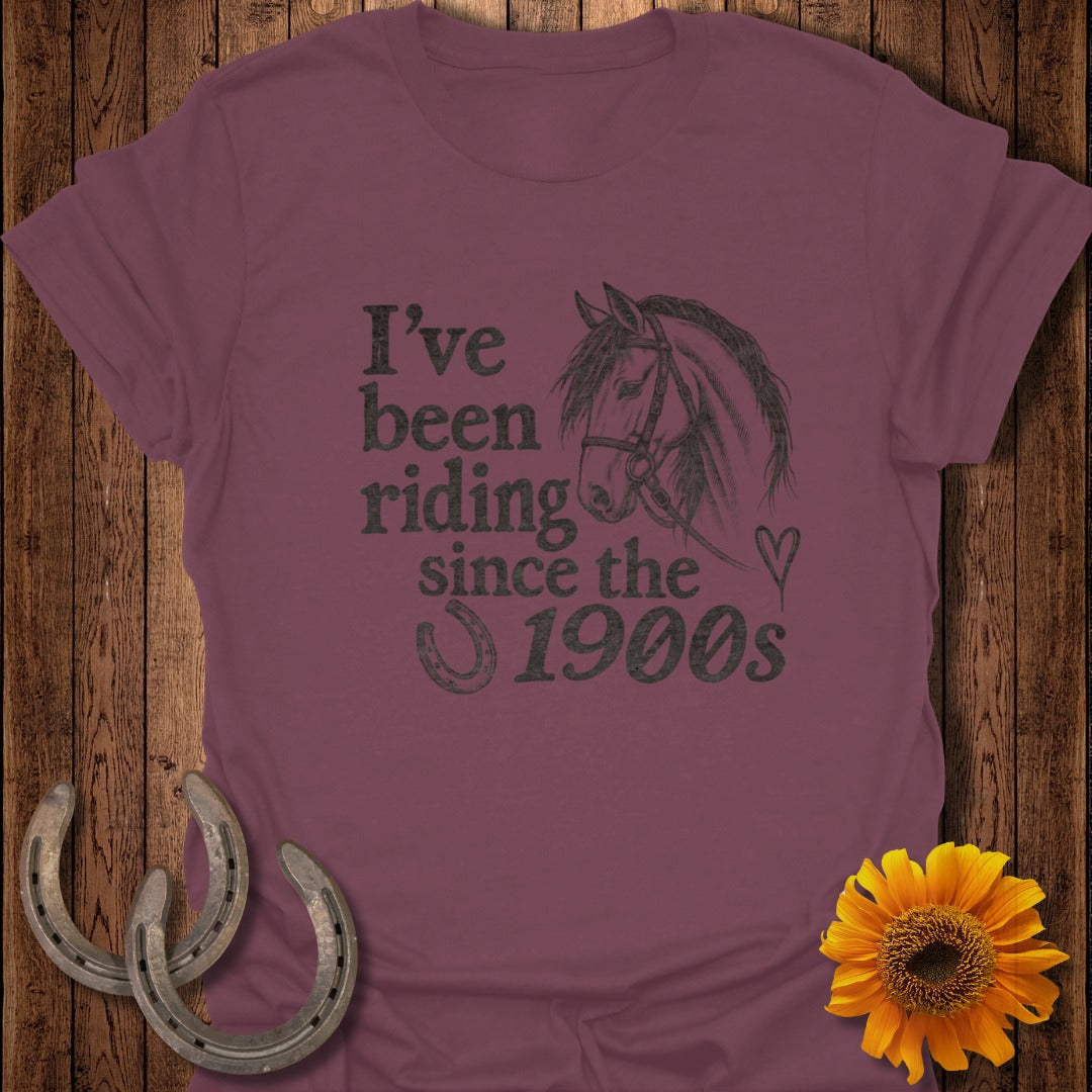Maroon t-shirt with horse graphic and text "I've been riding since the 1900s".