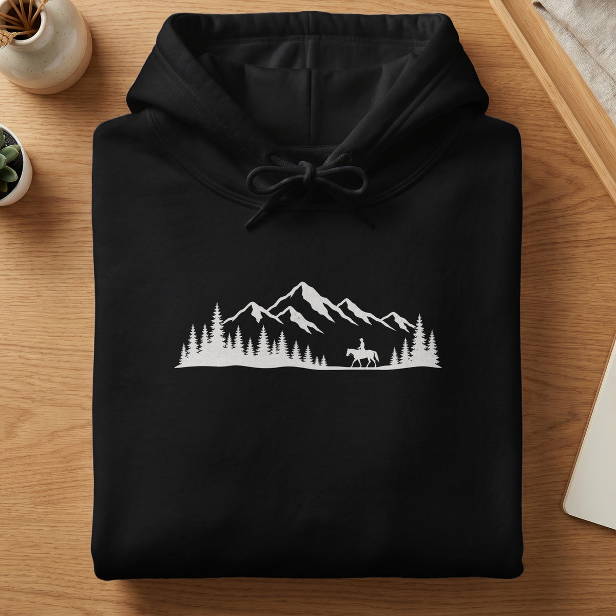 Black hoodie with white mountain and horse rider graphic.
