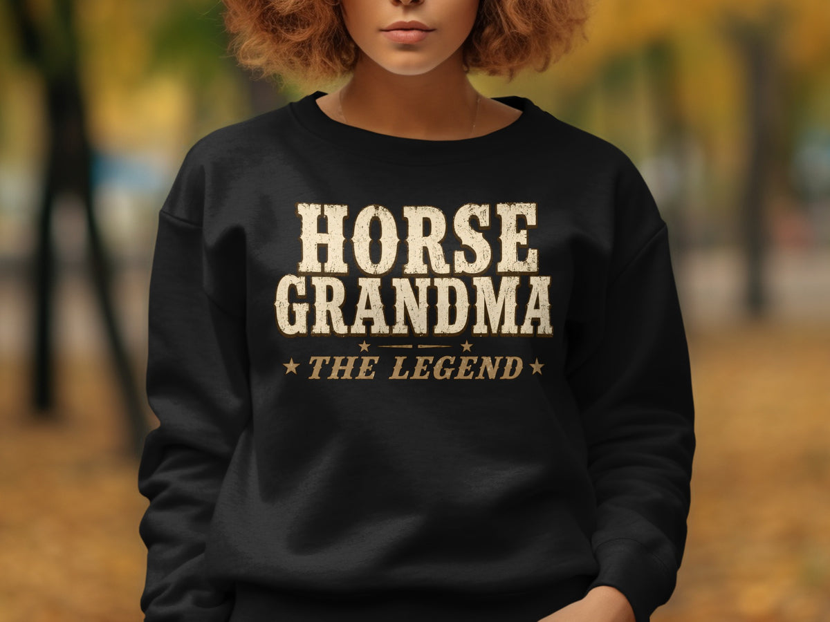Black sweatshirt with "HORSE GRANDMA ★ THE LEGEND" printed in distressed cream text.