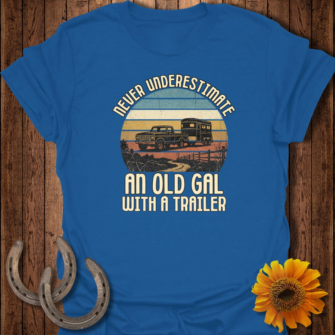 Blue t-shirt with "Never Underestimate An Old Gal With A Trailer" text and truck with trailer graphic.