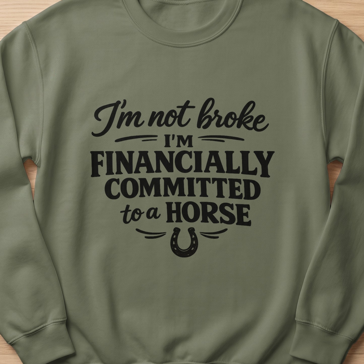 Olive green sweatshirt with text "I'm not broke I'm financially committed to a horse" and a horseshoe.