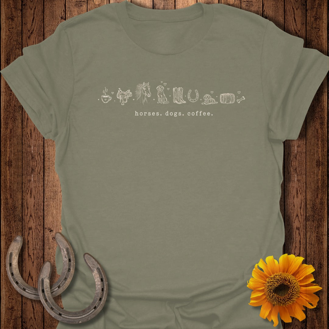 Olive green t-shirt with line drawings of horses, dogs, and coffee cup.