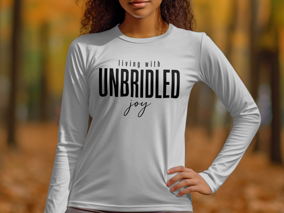 White long-sleeve shirt with black text "living with UNBRIDLED joy."