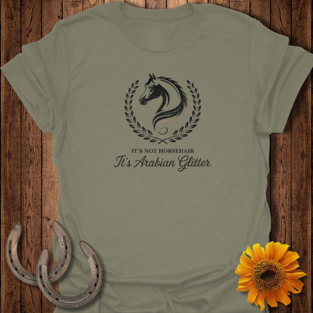 Olive green t-shirt with a horse head logo and text: It's not horsehair, it's Arabian glitter.