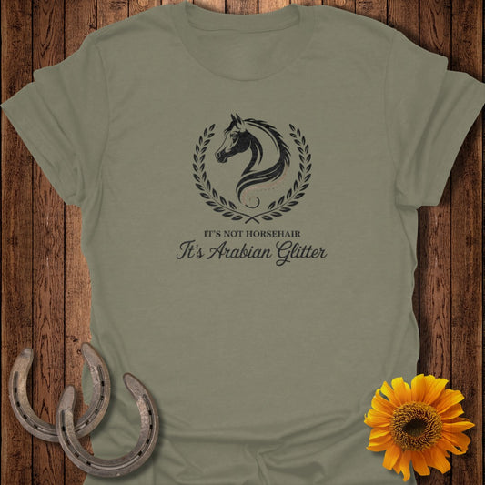 Olive green t-shirt with a horse head logo and text: It's not horsehair, it's Arabian glitter.