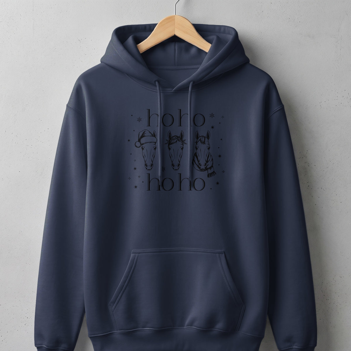Navy hoodie with "ho ho ho" text and three horses wearing festive accessories.