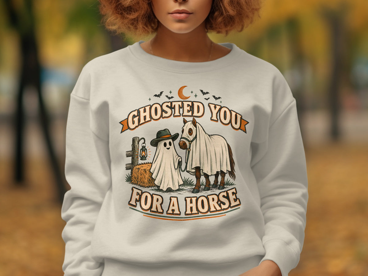 Ghosted You For A Horse Halloween graphic on a cream sweatshirt.