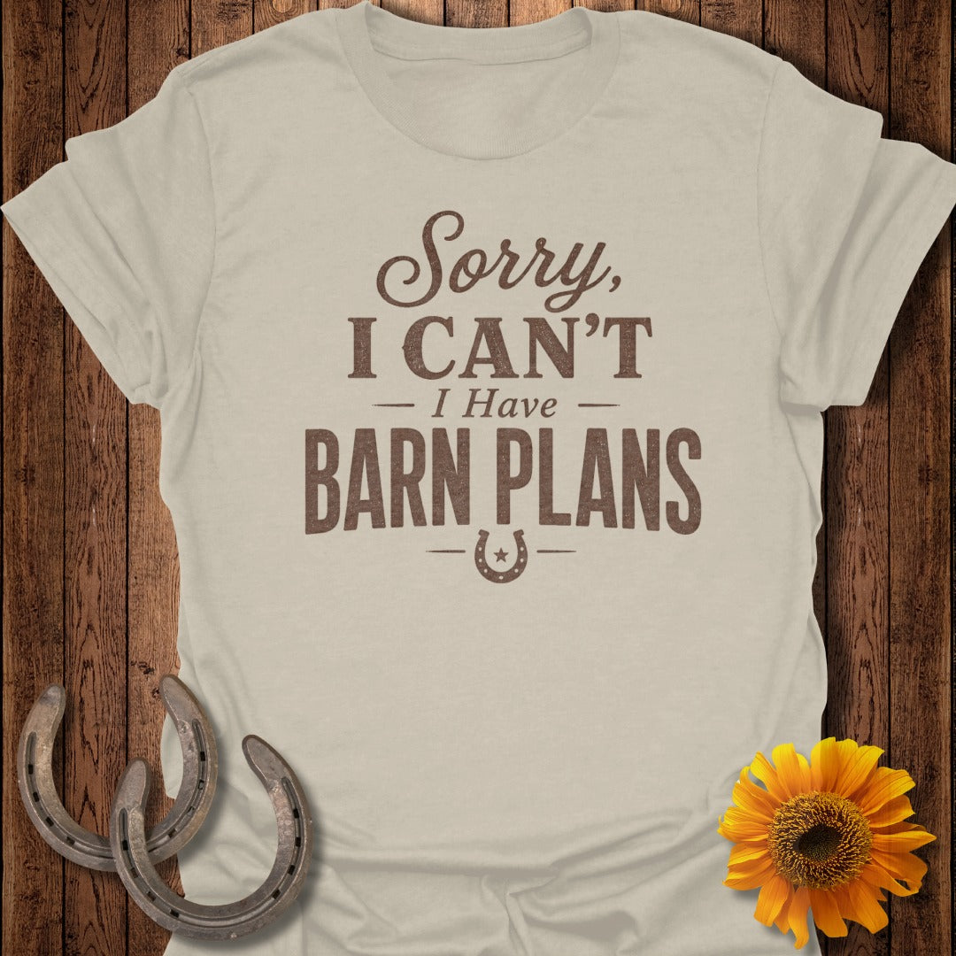 Light tan t-shirt with brown text "Sorry, I Can't - I Have Barn Plans" and horseshoe graphic.