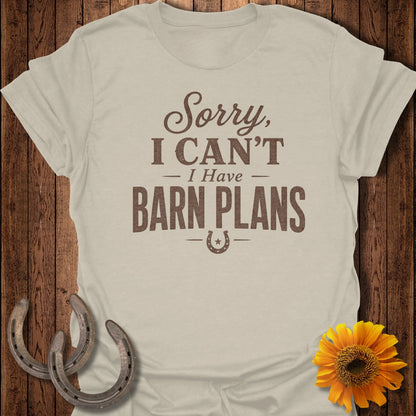 Light tan t-shirt with brown text "Sorry, I Can't - I Have Barn Plans" and horseshoe graphic.