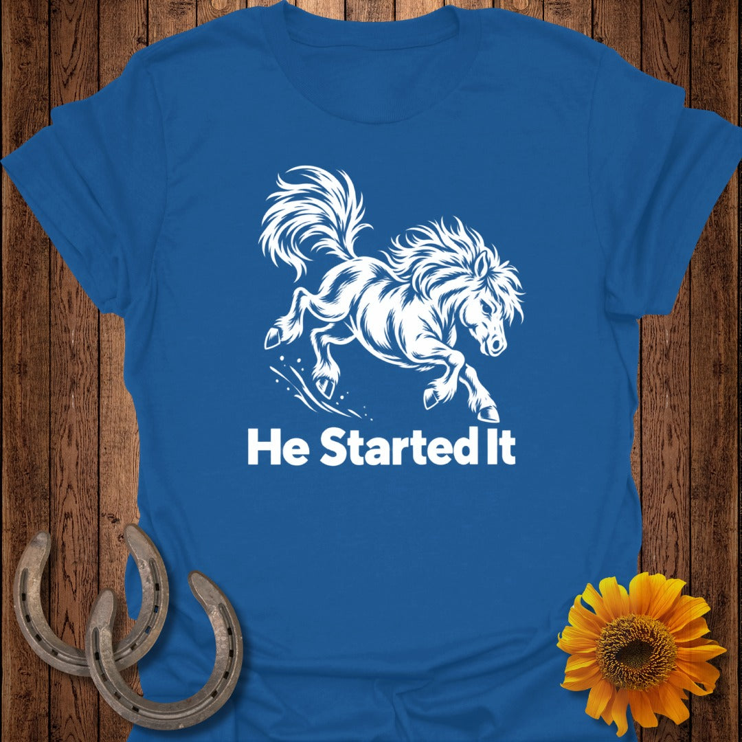 Blue t-shirt with white graphic of a galloping horse and text "He Started It".