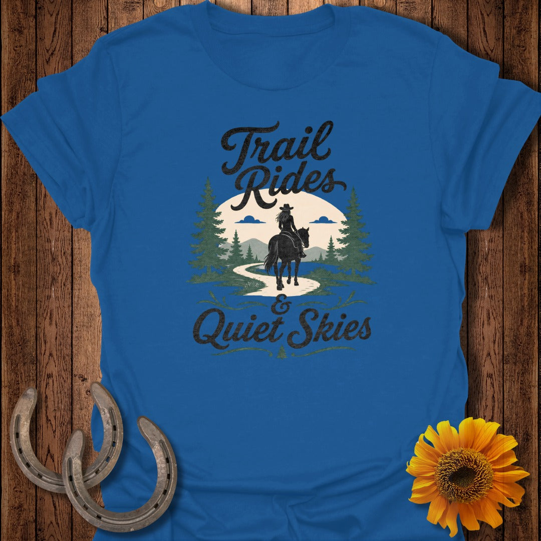 Blue t-shirt with "Trail Rides & Quiet Skies" text and horse rider silhouette.