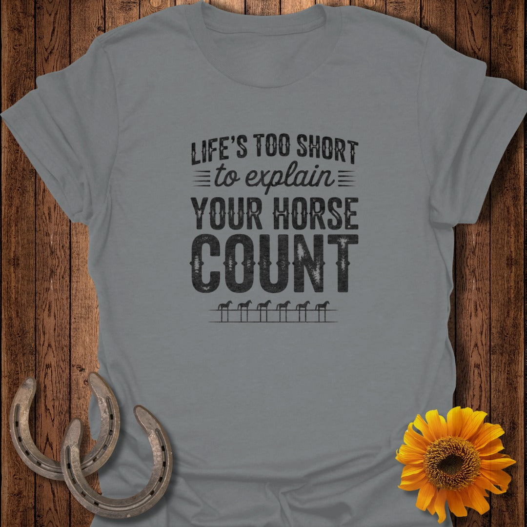Grey t-shirt with text "LIFE'S TOO SHORT to explain YOUR HORSE COUNT" and horseshoes.