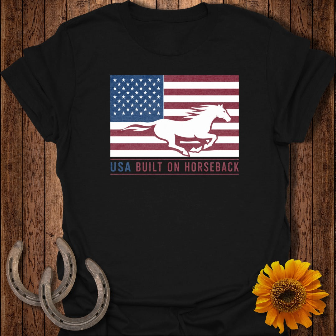 Black t-shirt with white running horse on American flag graphic and text "USA BUILT ON HORSEBACK".