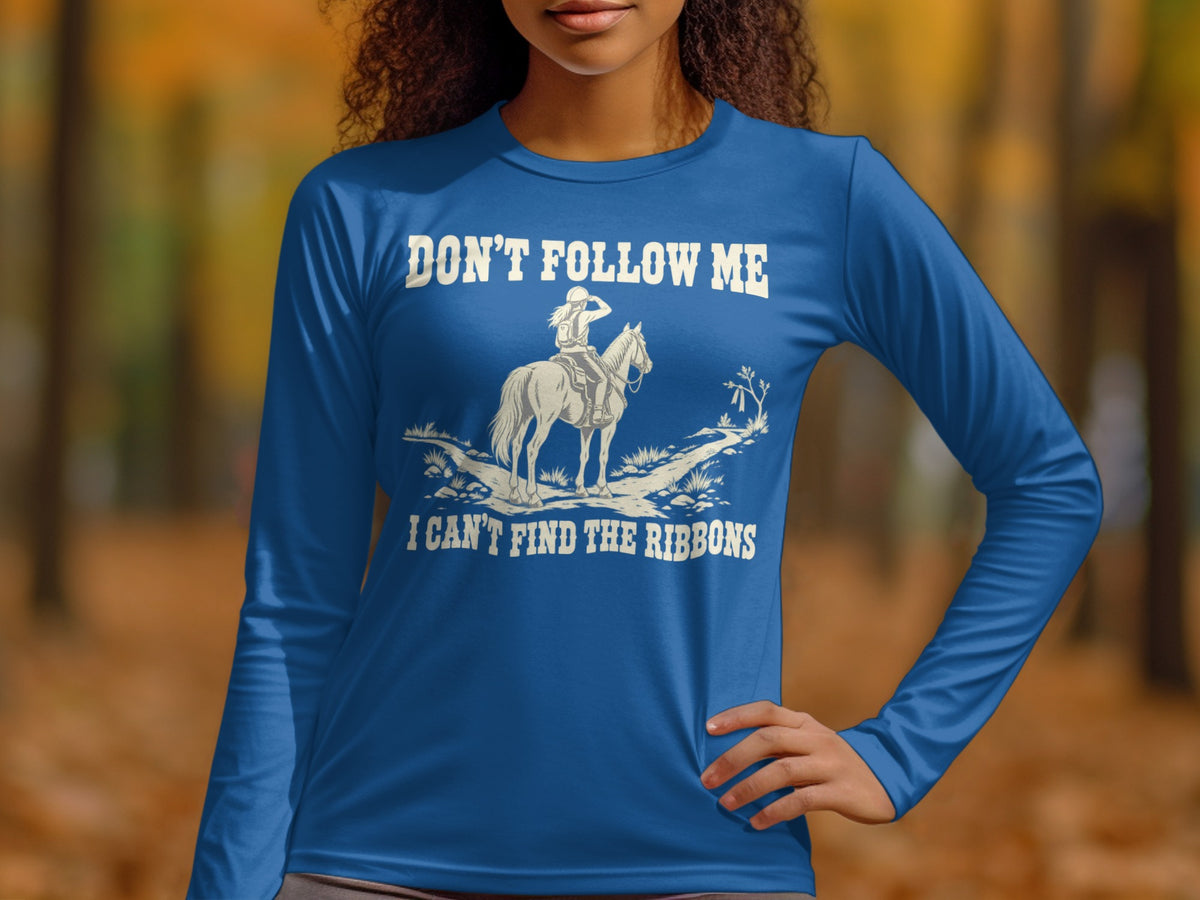 A person wearing a royal blue long-sleeve shirt with equestrian graphic art and text.