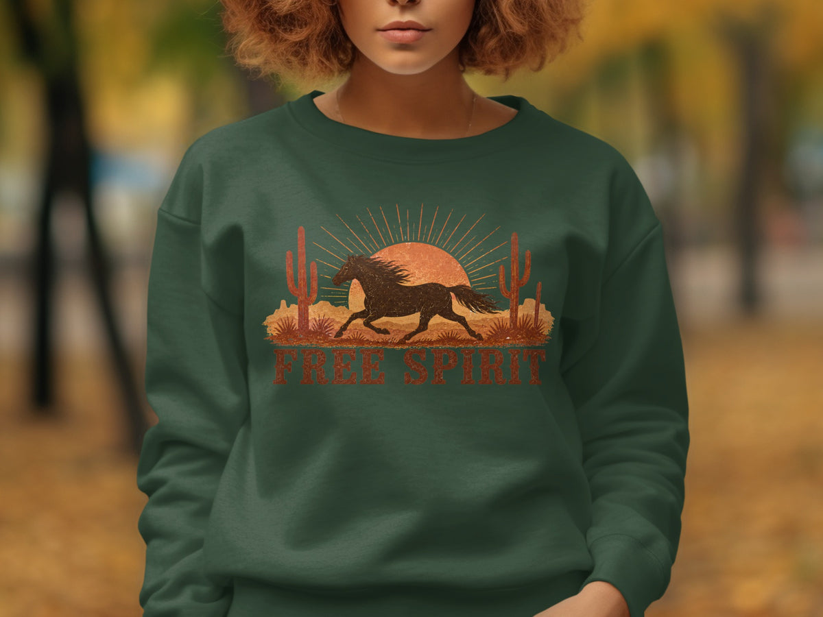 Green sweatshirt with a desert scene graphic featuring a running horse and "Free Spirit" text.