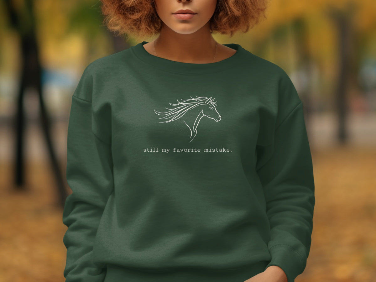 Dark green sweatshirt with white horse outline and text "still my favorite mistake."