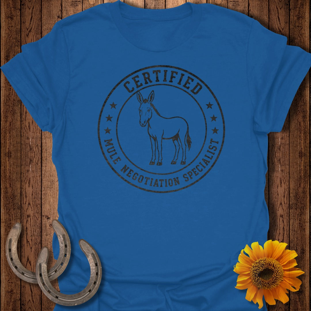 Blue t-shirt with a circular graphic that says "Certified Mule Negotiation Specialist".