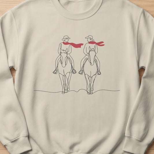 Line art of two people on horseback wearing hats and red scarves.