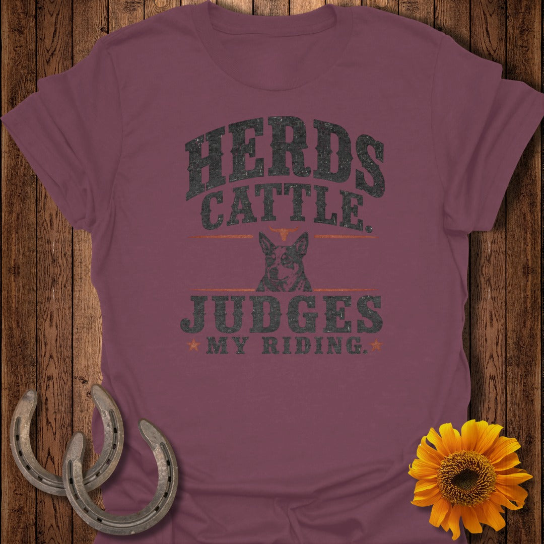 "Herds Cattle Judges My Riding" graphic on maroon t-shirt with dog and horseshoes.