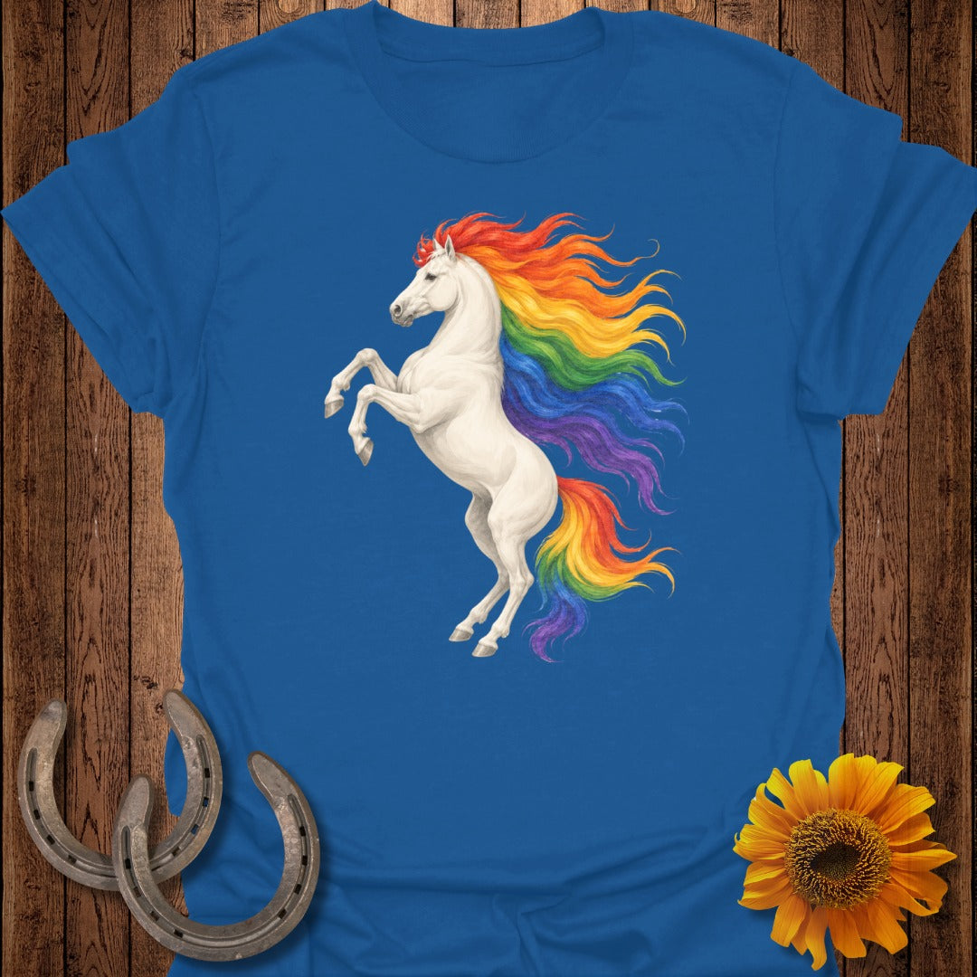 White unicorn with rainbow mane rearing up, on a blue t-shirt.