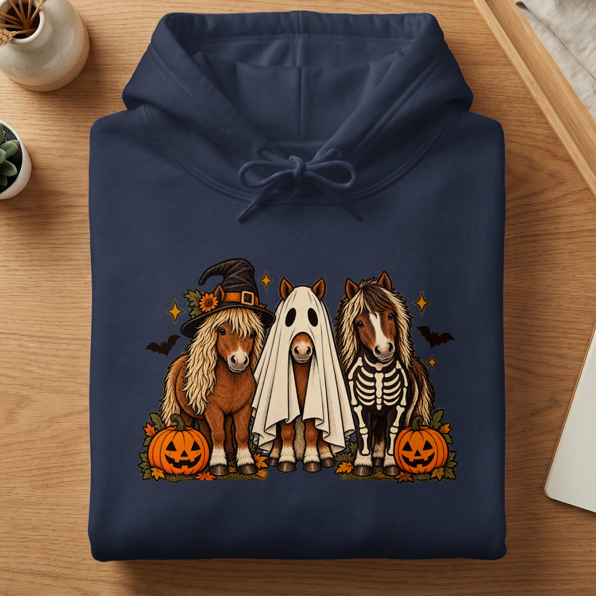 Three horses in Halloween costumes: witch hat, ghost, and skeleton.