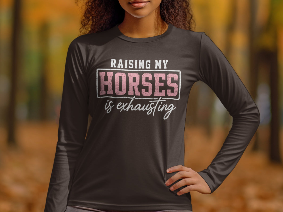 Dark long-sleeve shirt with "RAISING MY HORSES is exhausting" graphic.