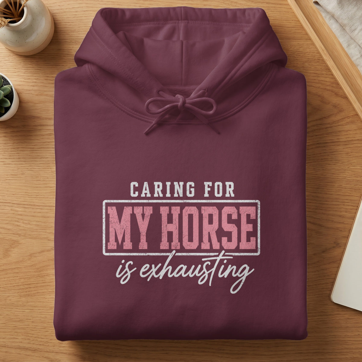 Maroon hoodie with "Caring for My Horse is Exhausting" text in distressed pink and white.