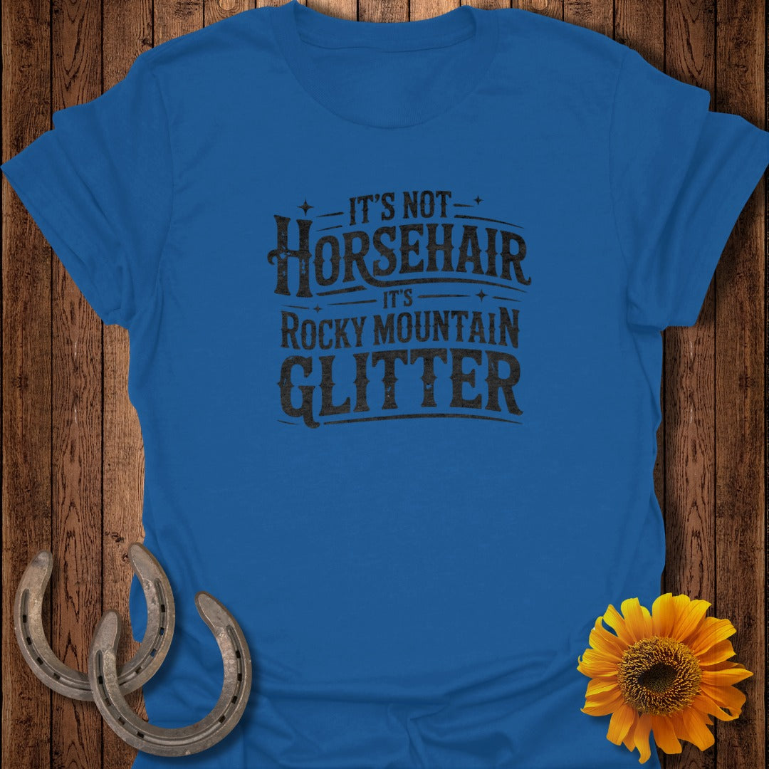 Blue t-shirt with "It's Not Horsehair It's Rocky Mountain Glitter" text.