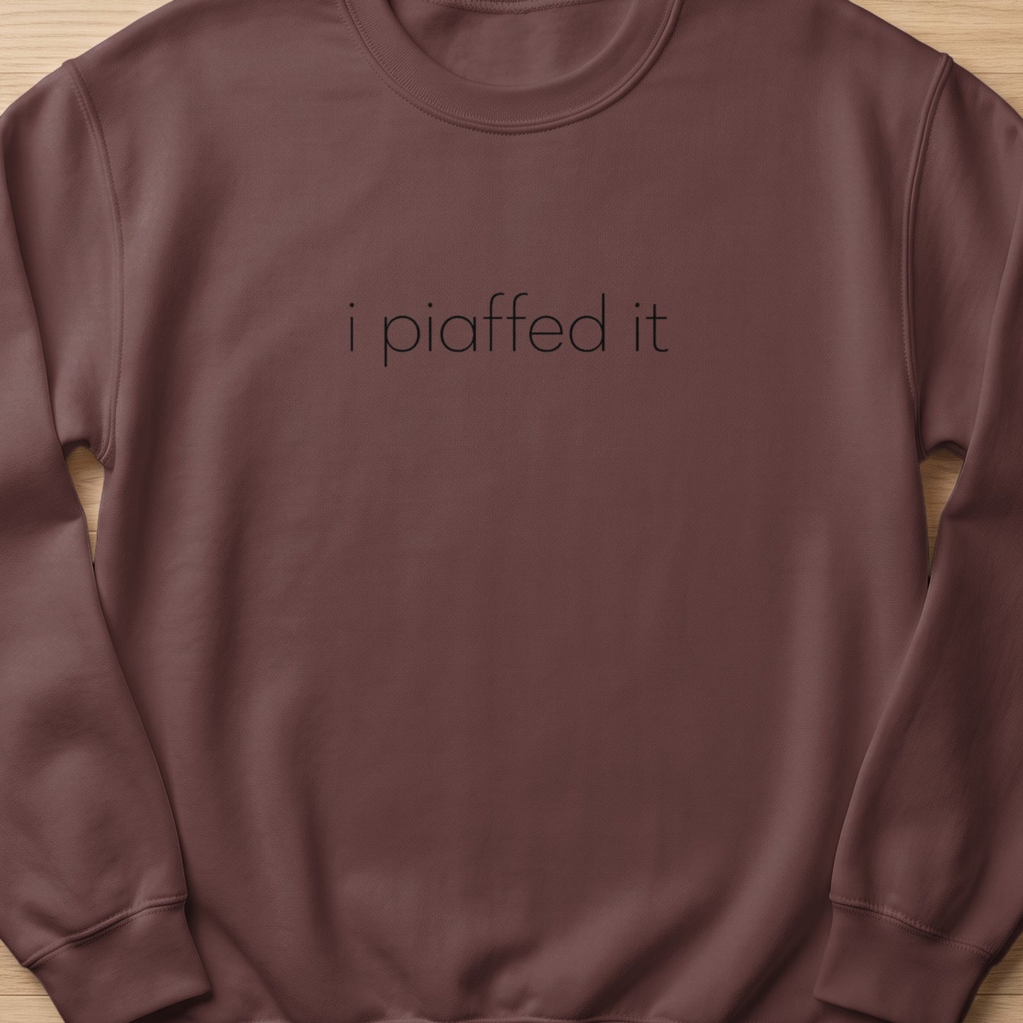 Brown sweatshirt with the text "i piaffed it" in black lettering.