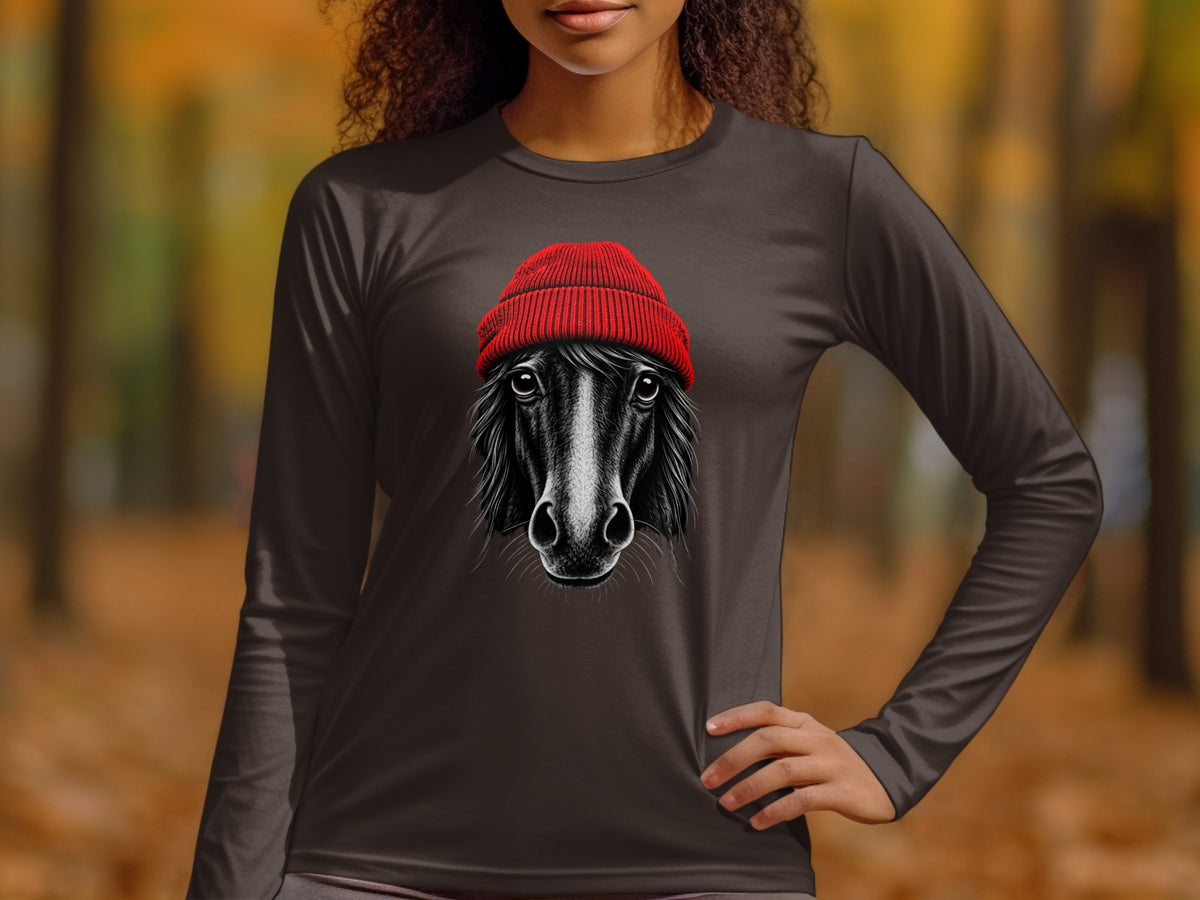 A woman wears a long-sleeve charcoal gray t-shirt featuring a graphic of a black horse wearing a red beanie.
