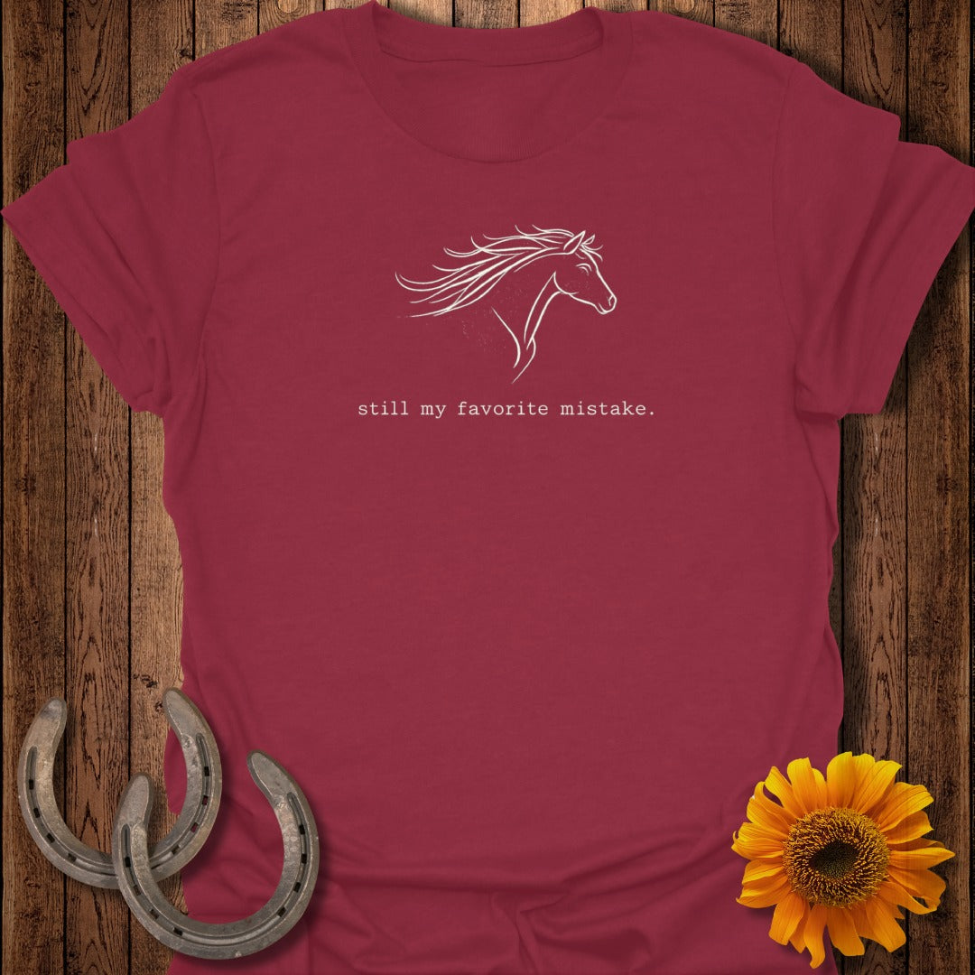 Maroon t-shirt with white line art of a horse and text "still my favorite mistake".