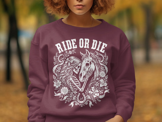 Maroon sweatshirt with "RIDE OR DIE" graphic of skeleton, horse, and horseshoe.