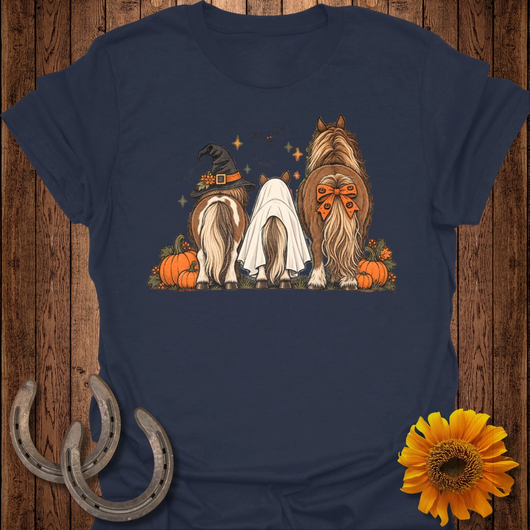 Three horses, one in a witch hat, one as a ghost, with pumpkins and autumn leaves.