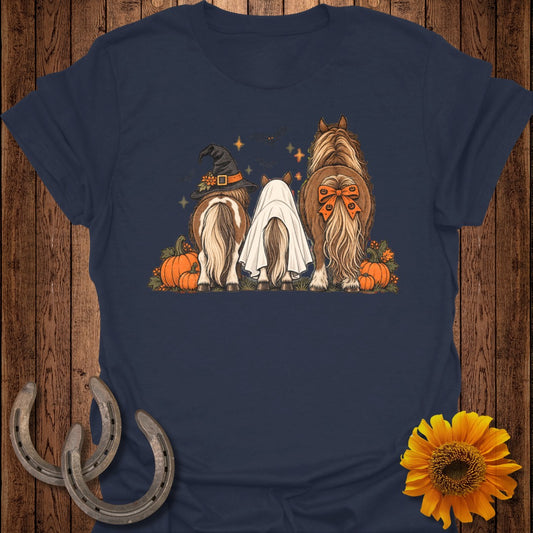 Three horses, one in a witch hat, one as a ghost, with pumpkins and autumn leaves.