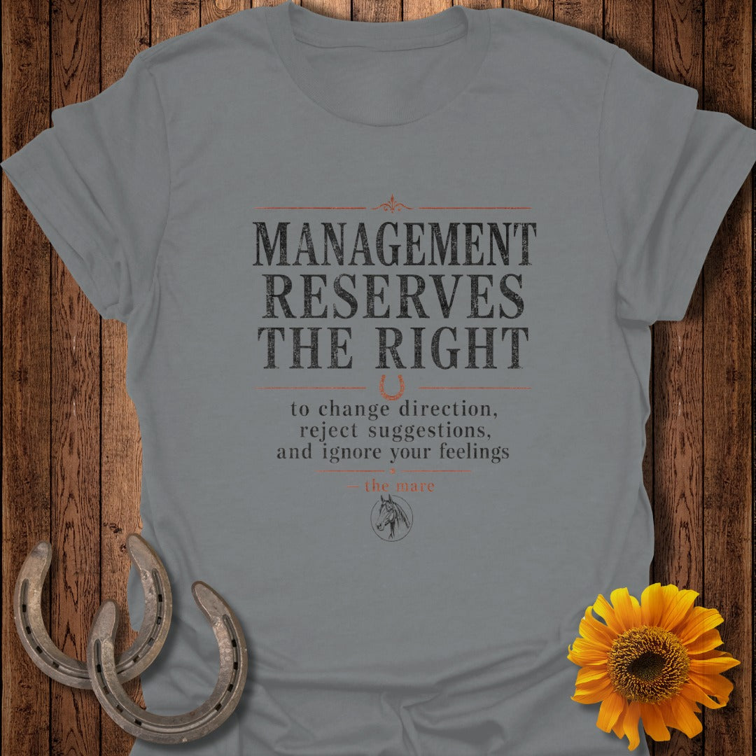 Grey t-shirt with text "Management reserves the right to change direction, reject suggestions, and ignore your feelings."