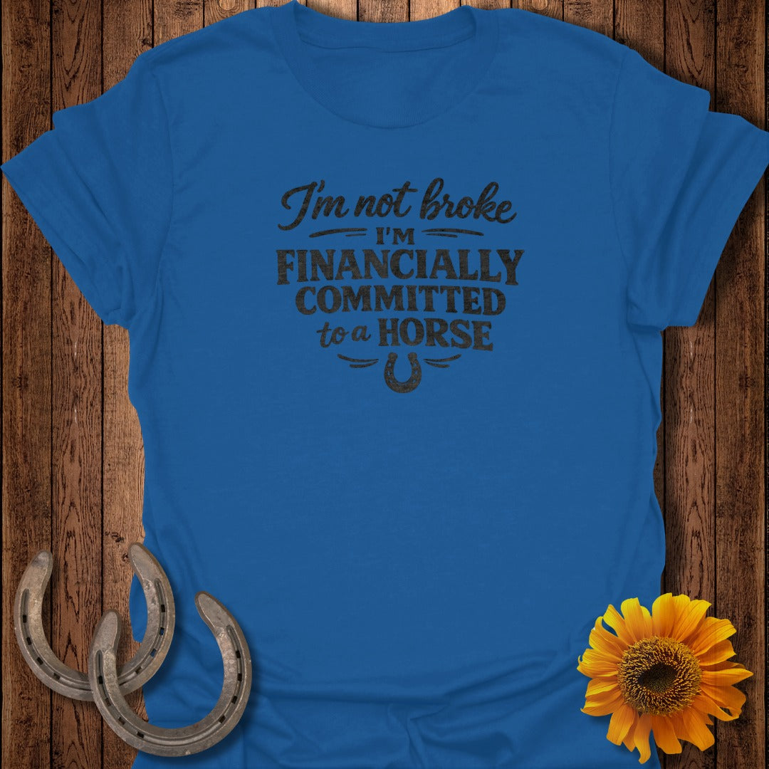 Blue t-shirt with "I'm not broke, I'm financially committed to a horse" text and horseshoe graphic.