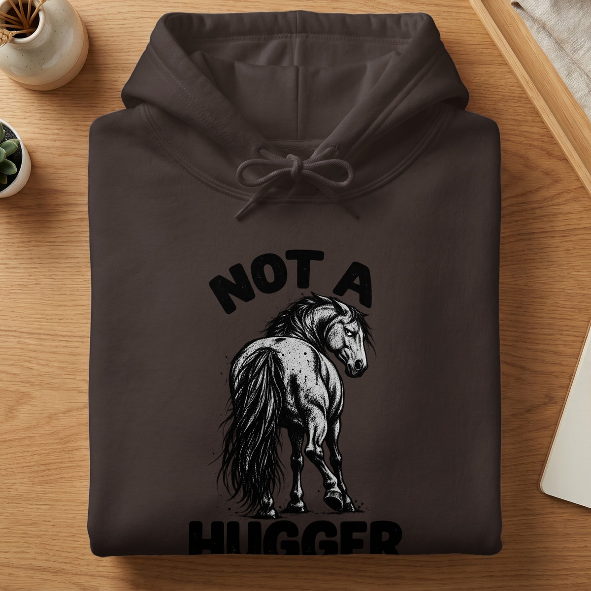 Brown hoodie with a black graphic of a horse and text "NOT A HUGGER".