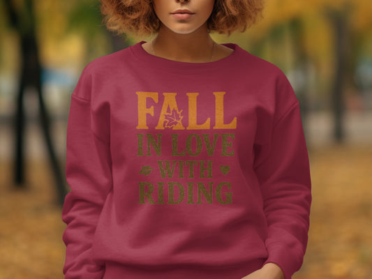 Maroon sweatshirt with "Fall in Love with Riding" graphic featuring a leaf, lips, and heart.