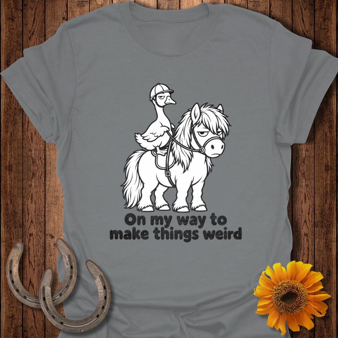 A gray t-shirt featuring a cartoon illustration of a duck riding a pony, with the text "On my way to make things weird".