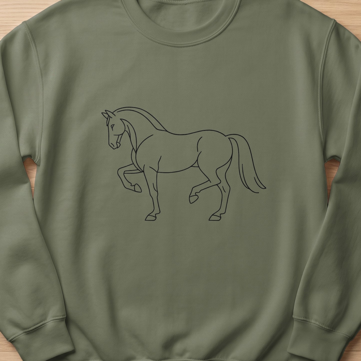Line art of a horse with one front leg raised on a green sweatshirt.