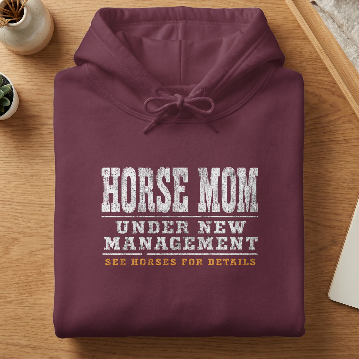 Maroon hoodie with white distressed text reading "HORSE MOM UNDER NEW MANAGEMENT SEE HORSES FOR DETAILS".