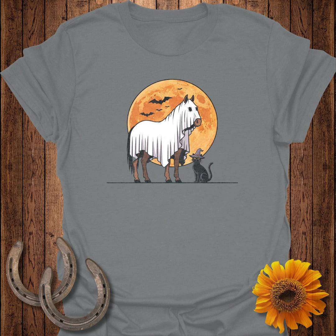 Horse wearing ghost costume with cat and witch hat under full moon.
