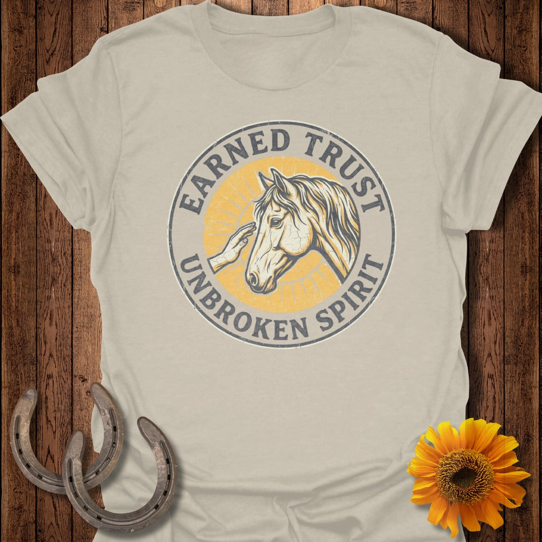 T-shirt with "Earned Trust, Unbroken Spirit" text and horse head graphic.