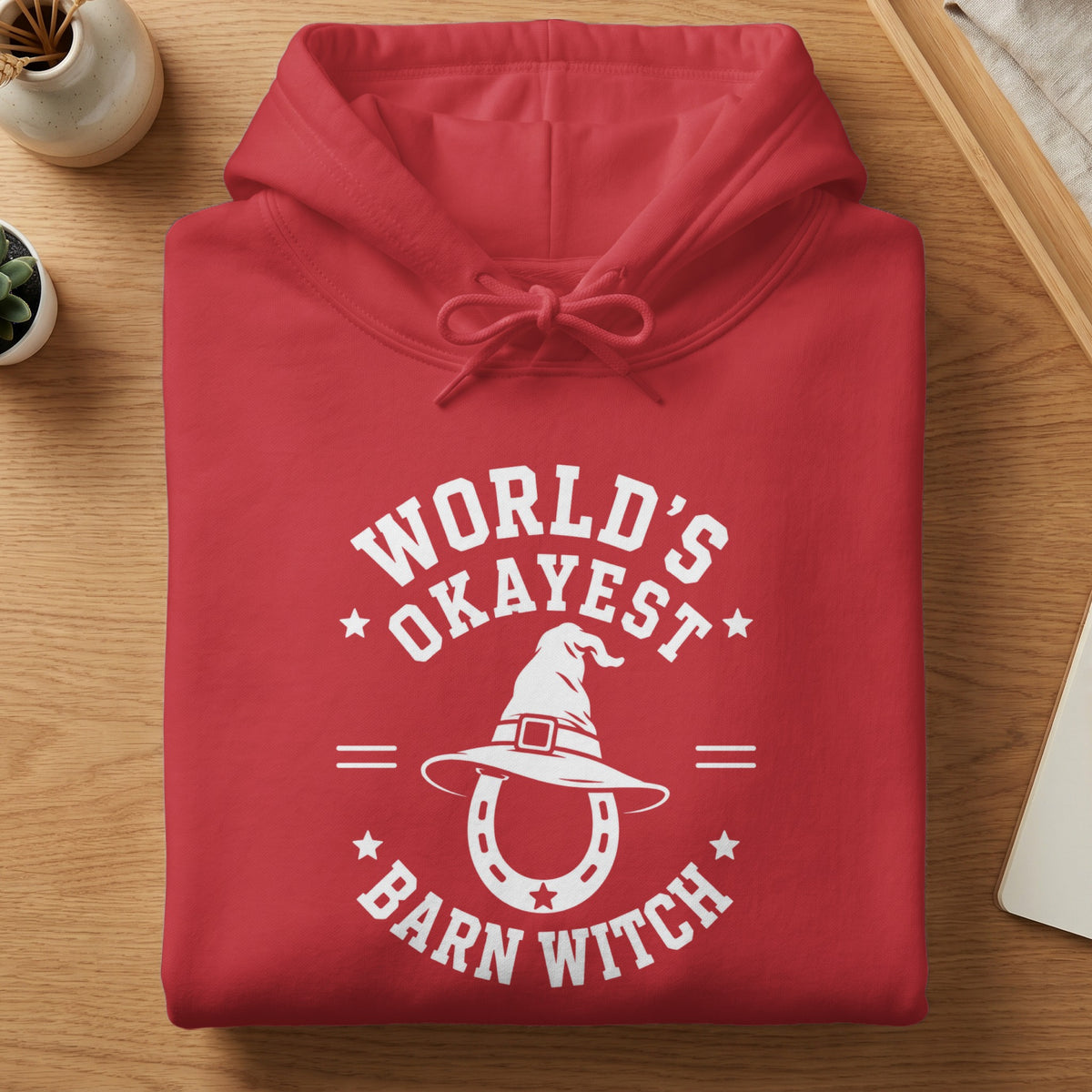 Red hoodie with white text and graphics of a witch hat over a horseshoe.