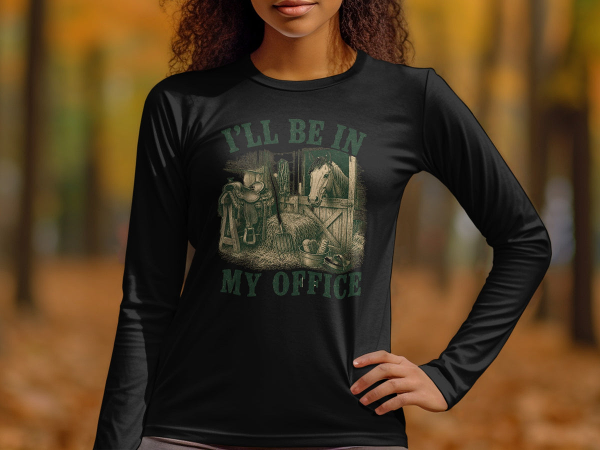 Black long-sleeve shirt with graphic of horse in stable and text "I'LL BE IN MY OFFICE".